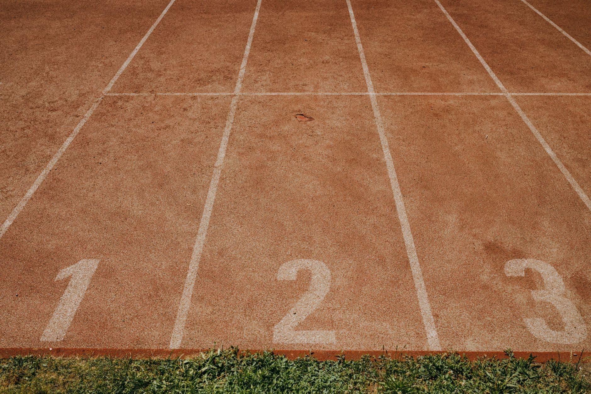 Overhead view of an athletics track with numbered lanes