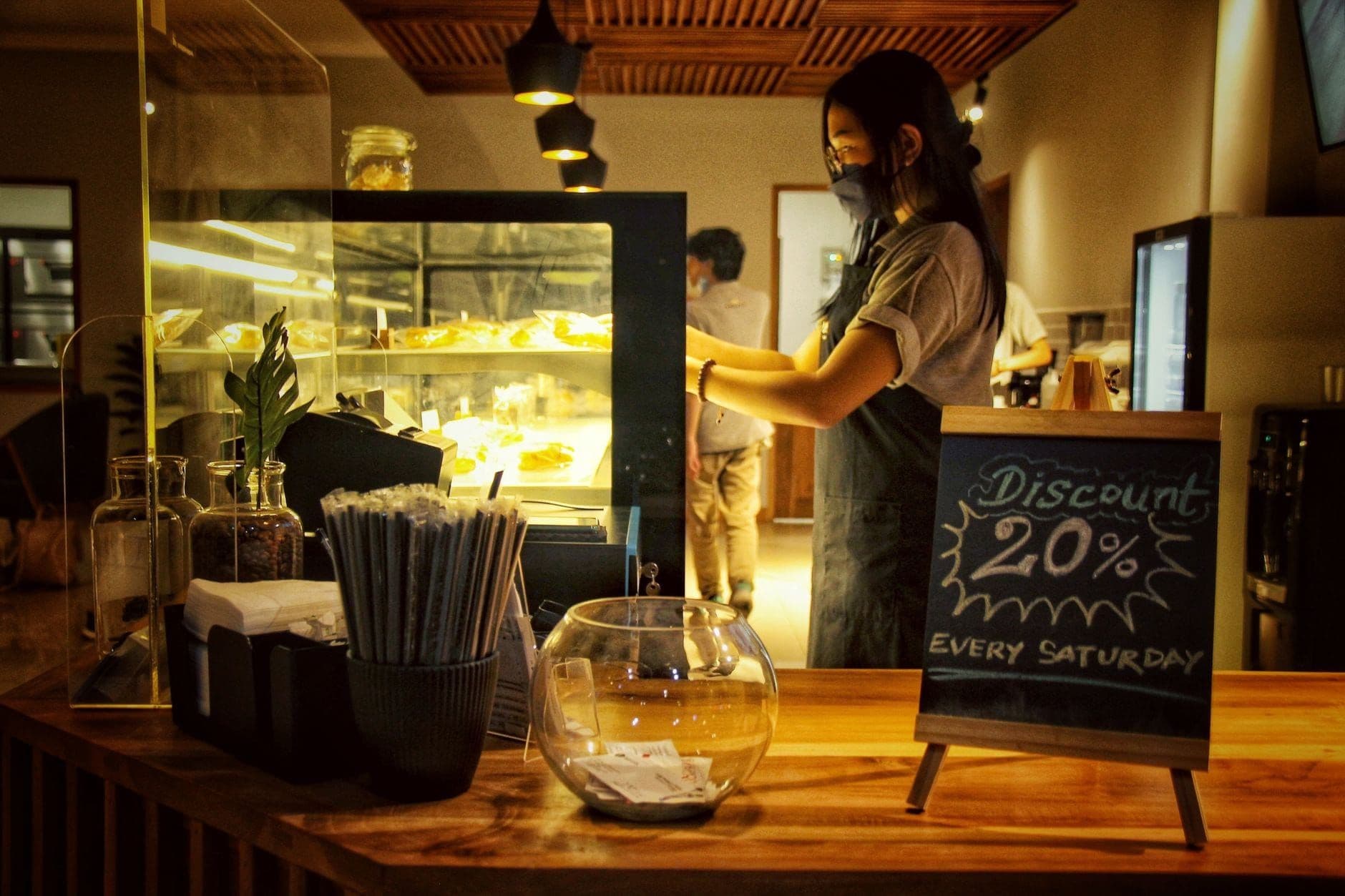 Cafe counter with a chalkboard sign advertising a weekly discount
