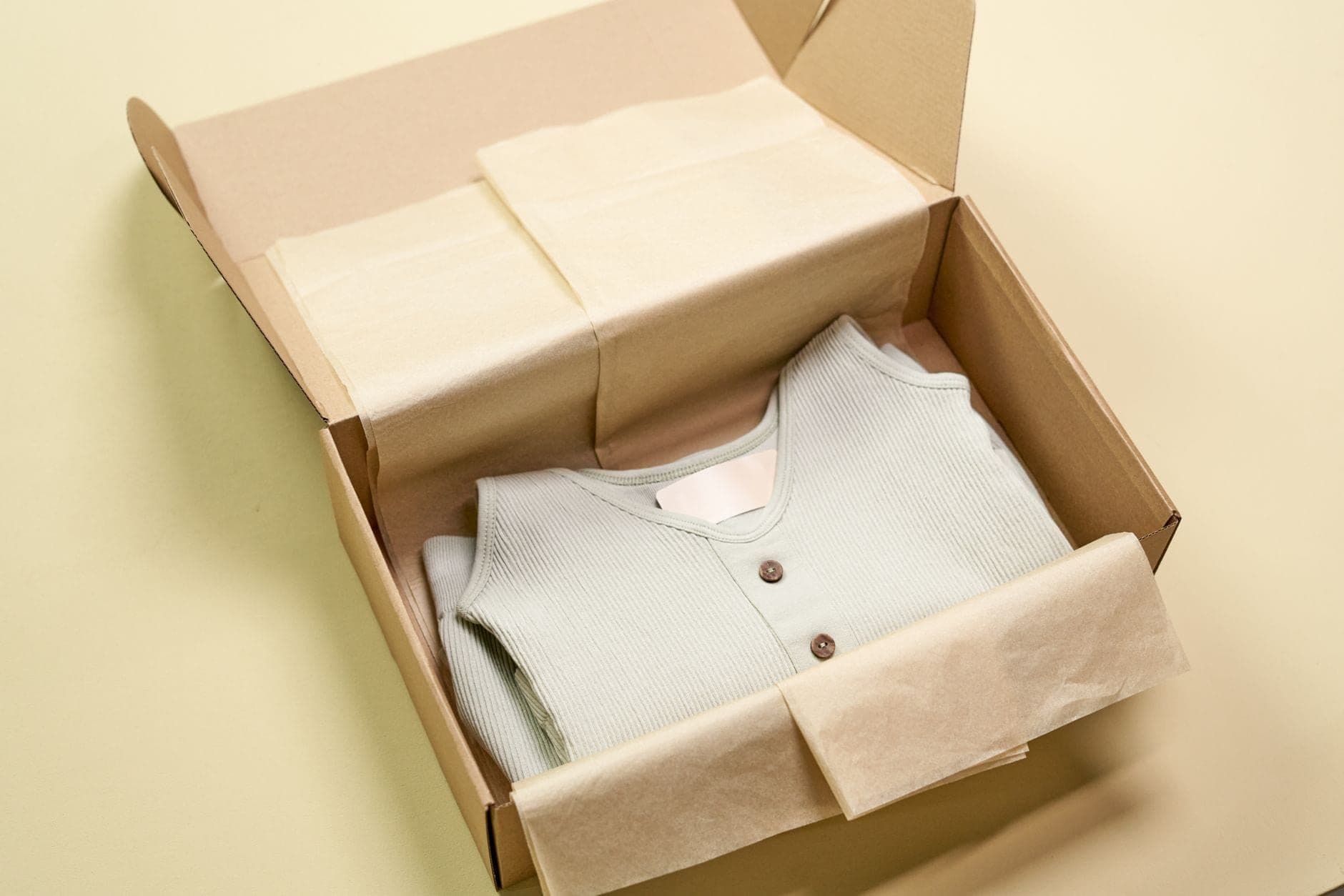 Folded garment packed neatly in a recyclable cardboard box