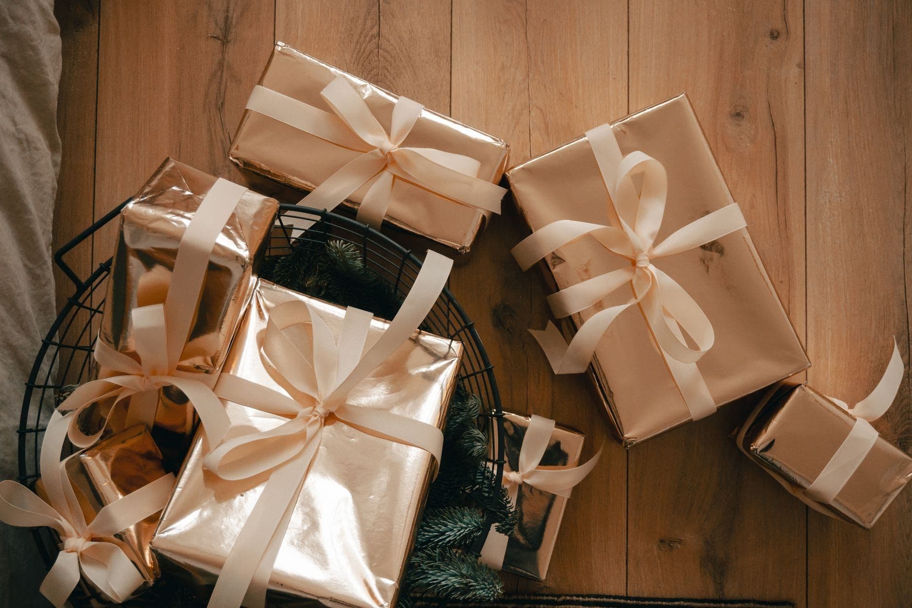 Gift boxes tied with ribbon arranged on a wooden surface