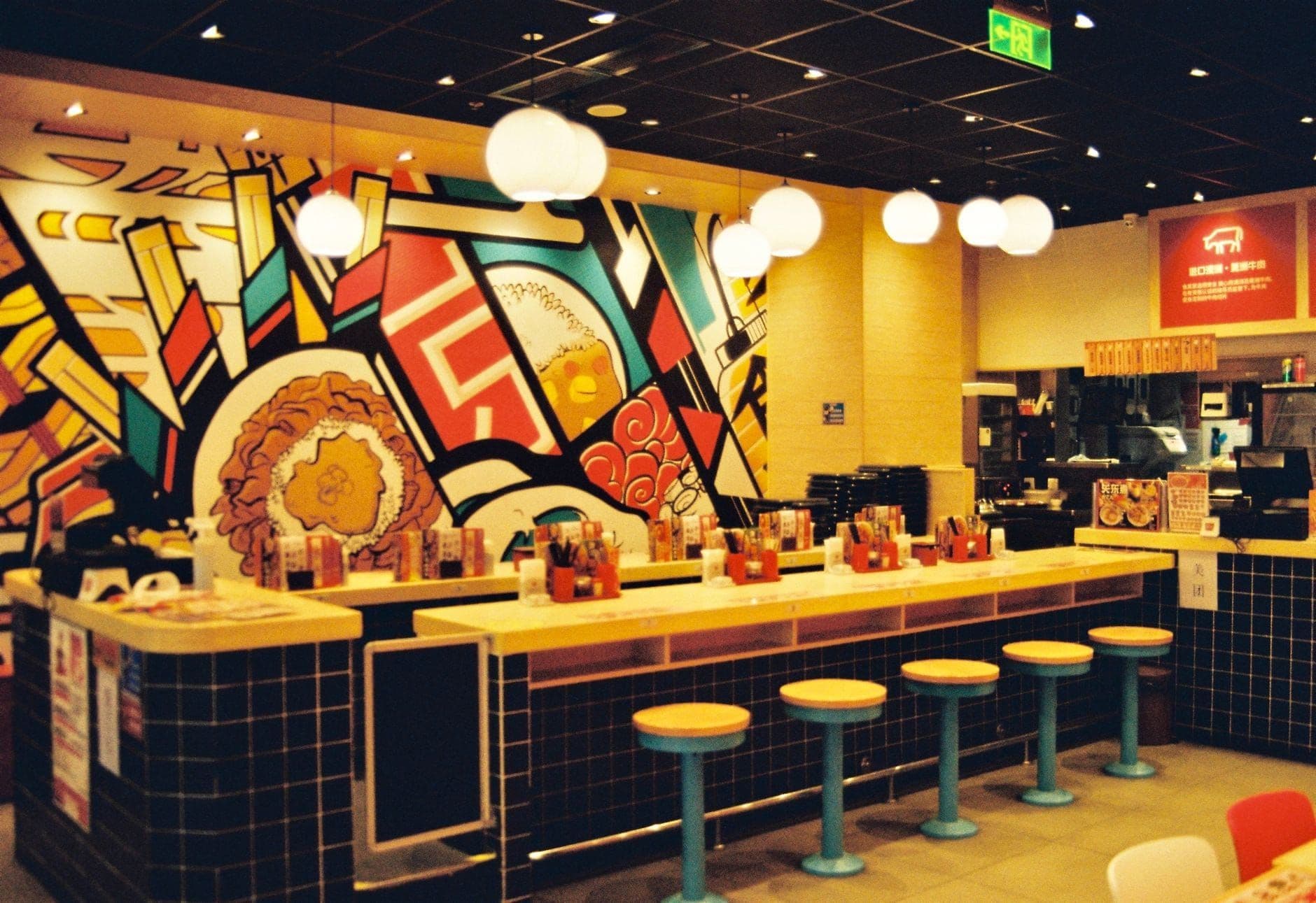Interior of a modern fast food restaurant with colorful wall art