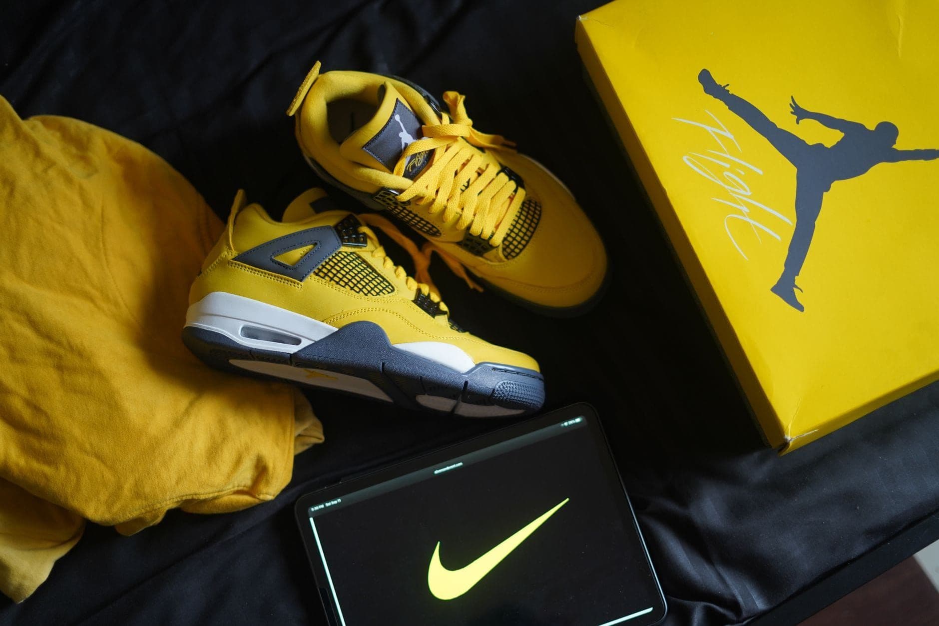 Yellow Air Jordan sneakers next to a branded shoe box