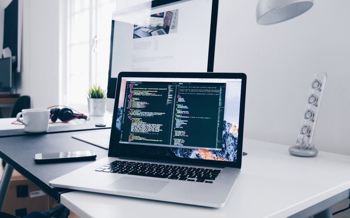 A laptop open to code on a developer workspace