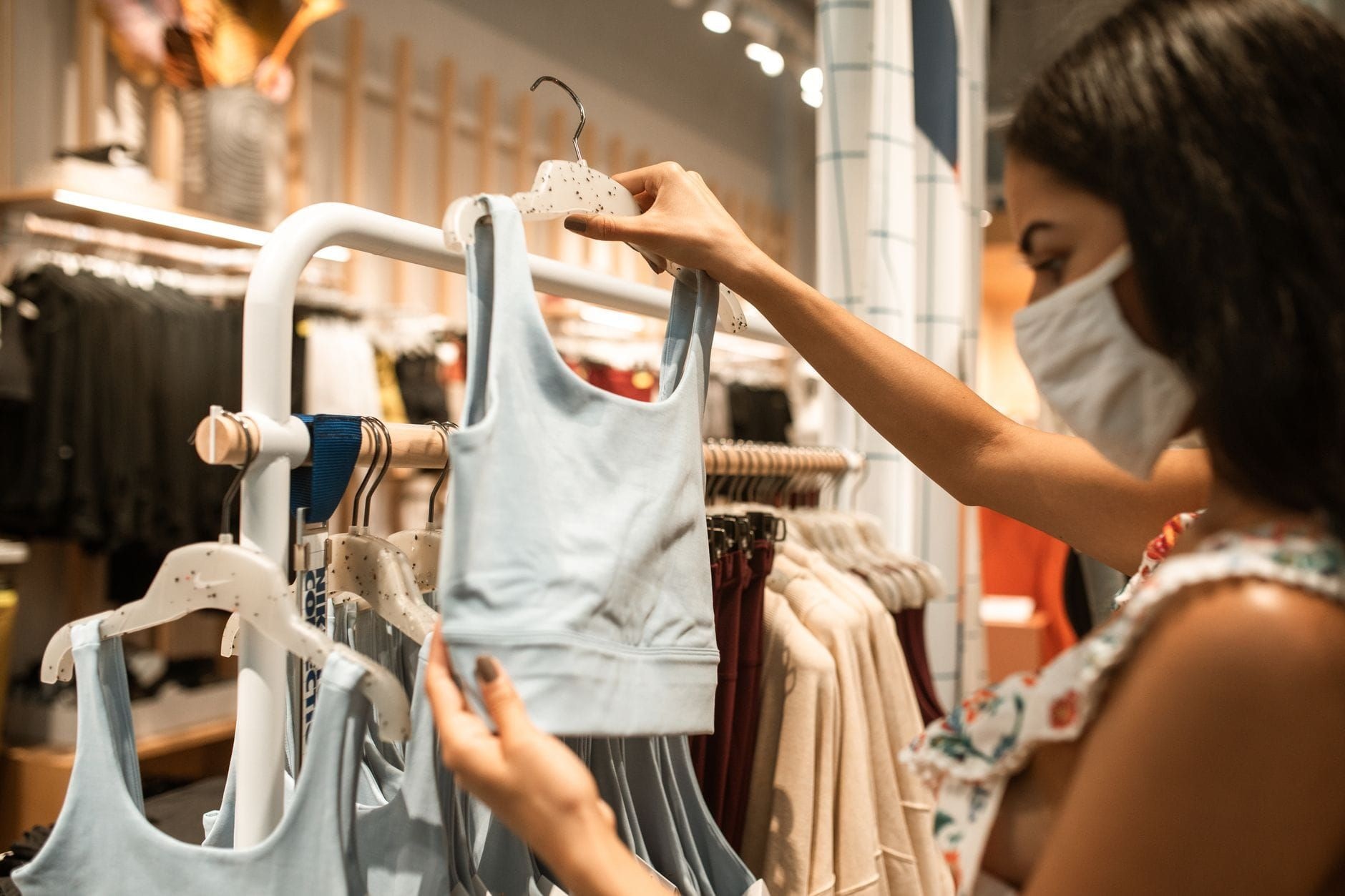Customer browsing activewear on a rack in a sportswear store