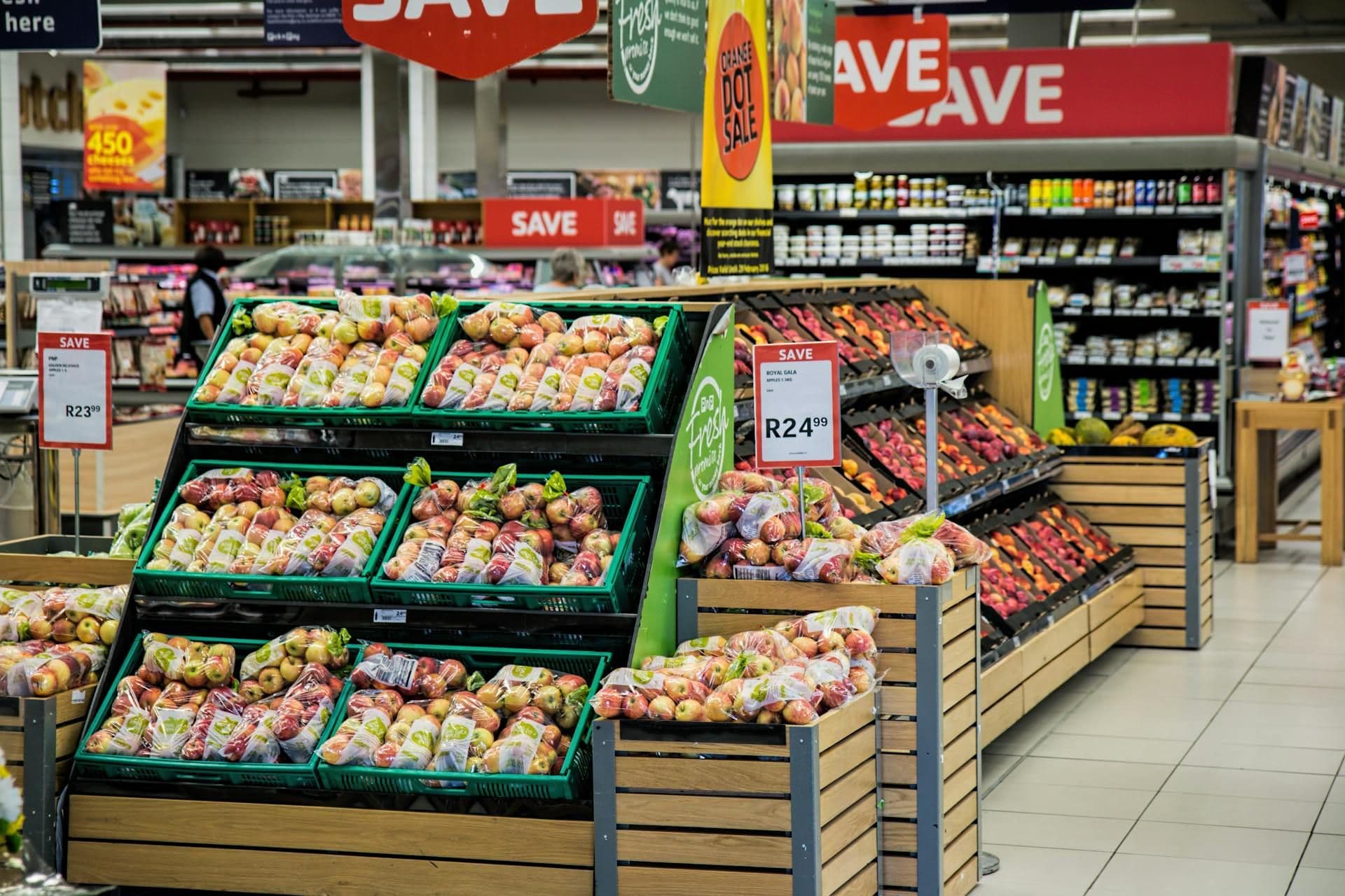 Grocery store aisle with discount signs and fresh produce